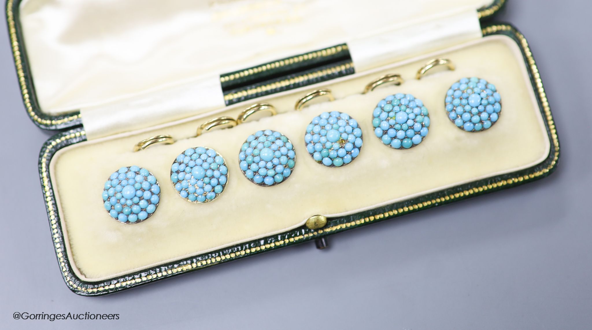 An early 20th century cased set of six yellow metal and turquoise set dress studs (stone missing)